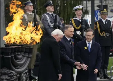  ?? (AP/Czarek Sokolowski) ?? Israel’s President Isaac Herzog (front from right), Polish President Andrzej Duda and German President Frank-Walter Steinmeier attend a wreath-laying ceremony Wednesday during a ‘Warsaw Ghetto Uprising’ commemorat­ion in Warsaw, Poland.