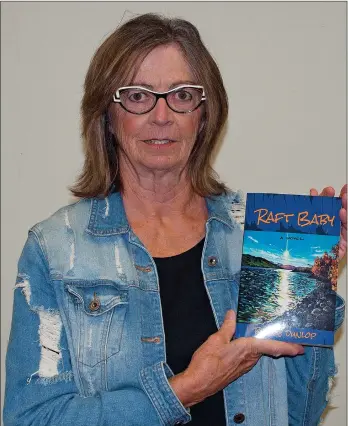  ?? SCOTT ANDERSON/SOUTHWEST BOOSTER ?? Bonnie Dunlop shows off a copy of her first historical novel Raft Baby, which has already been selected as one of the featured works for Saskatchew­an Book Publishing Week which runs from September 28 to October 2.