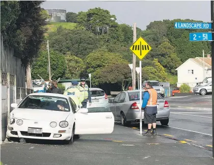  ?? Picture / Brett Phibbs ?? Police blame speed and a wet road for yesterday’s crash on the corner of Landscape and Mt Eden Rds.