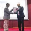  ??  ?? Chairman of the Board, Dr. Baby Sam Saamuel, presented the first copy of the manual to P. Prabhakara­n, Principal of Indian School Al Maabela.