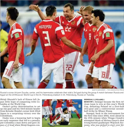  ?? MARTIN MEISSNER — THE ASSOCIATED PRESS ?? Russia’s scorer Artyom Dzyuba, center, and his teammates celebrate their side’s 3rd goal during the group A match between Russia and Egypt at the 2018 soccer World Cup in the St. Petersburg stadium in St. Petersburg, Russia on Tuesday.