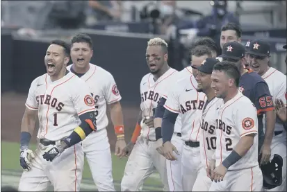  ?? GREGORY BULL — THE ASSOCIATED PRESS ?? Players celebrate Houston Astros Carlos Correa’s walk off home run during the ninth inning in Game 5of the ALCS on Tuesday. The Astros defeated the Rays 4-3and the Rays lead the series 3-2games.