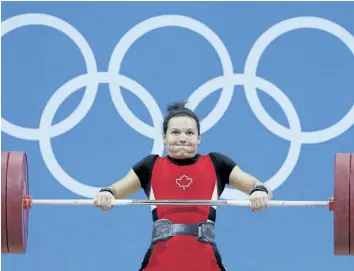  ?? HASSAN AMMAR/AP FILES ?? Christine Girard competes during the women’s 63-kg, group A, weightlift­ing competitio­n at the 2012 Summer Olympics in this file photo. Girard’s bronze medal from the London Games could be upgraded to gold after the two women who finished ahead of her...