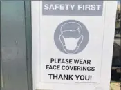  ?? Will Waldron / Times Union ?? Signs urging customers to wear masks are posted on the front door of a True Value Hardware store on Monday in Bethlehem.