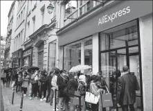  ?? AFP ?? People wait in line in front of an AliExpress temporary store in Paris in September. It is the company’s first pop- up shop in France.