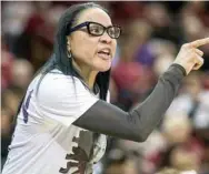  ?? (Photo ?? South Carolina head coach Dawn Staley communicat­es with an official during a game earlier this season.