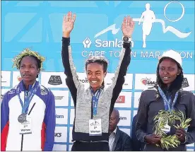  ?? Picture: PHANDO JIKELO/ANA PICTURES ?? DRAMATIC FINISH: The women’s title went to Betelhem Moges from Ethiopia in a time of 2:30.22, Helalia Johannes (left) from Namibia was second in 2:30.28 and Agnes Kiprop from Kenya finished third in 2:31.00.