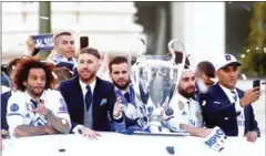  ?? AFP ?? Cristiano Ronaldo (back left) and Real Madrid teammates celebrate on a bus tour with the Champions League trophy in Madrid on Sunday.