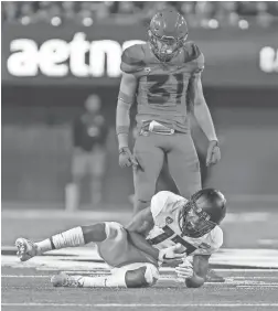  ?? JACOB SNOW/ICON SPORTSWIRE ?? Arizona safety Tristan Cooper (31) looks down at Oregon receiver Dillon Mitchell on Saturday in Tucson.