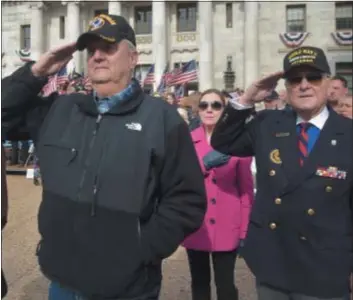  ?? PETE BANNAN - DIGITAL FIRST MEDIA ?? Vietnam veteran Joe Farah of Media and World War II veteran Ed Buffman of Media salute the large American flag during the Delaware County Veterans Day Parade and service Monday at the Delaware County Courthouse in Media. Veterans Day celebratio­ns are one thing to be thankful for this year.