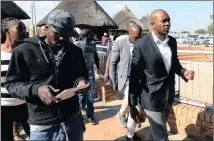 ??  ?? UNWANTED: DA Leader Mmusi Maimane, right, and City of Tshwane mayor Solly Msimanga were escorted by police out of Ga-Rankuwa yesterday after an angry crowd accused the DA-led administra­tion of service delivery failures.