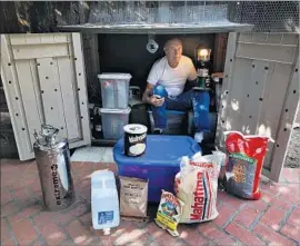  ?? Mel Melcon Los Angeles Times ?? TRENT SANDERS, 76, a retired L.A. County sheriff ’s deputy, poses inside the well-stocked earthquake supply shed at his home in La Cañada Flintridge.