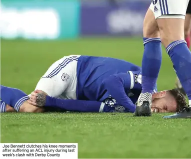  ??  ?? Joe Bennett clutches his knee moments after suffering an ACL injury during last week’s clash with Derby County