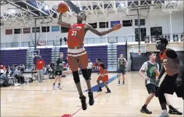  ?? Paul Sancya ?? Emoni Bates skies for a rebound during a game in Saline, Mich. The 6-foot-7-inch eighth-grader is one of the nation’s most coveted youth players by college coaches.