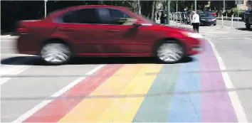  ?? MICHELLE BERG ?? Volunteers cleaned up the Pride crosswalk after it was defaced by tire tracks.