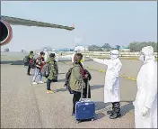  ?? PTI ?? Health officials screen Indians who were evacuated from Wuhan, at the airport in New Delhi, on February 2.