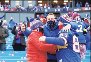  ?? Bryan M. Bennett / Getty Images ?? Fans celebrate after the Bills’ win over the Colts in a wild-card playoff game Saturday.