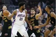  ?? RON SCHWANE — THE ASSOCIATED PRESS ?? 76ers center Joel Embiid operates against Raul Neto, left, and forward Evan Mobley on March 15.