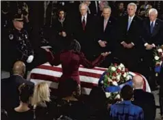  ?? AP ?? Maya Rockeymoor­e Cummings, widow of the late Rep. Elijah Cummings, stands over his casket as he lies in state in Capitol.