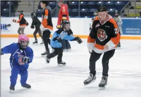  ?? NEWS PHOTO RYAN MCCRACKEN ?? Medicine Hat Tigers defenceman Linus Nassen races with a fan during the team’s annual Skate with the Tigers event in support of Big Brothers and Big Sisters of Medicine Hat and District on Wednesday at Canalta Centre.