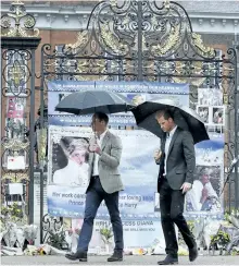  ?? KIRSTYWIGG­LESWORTH/ GETTY IMAGES ?? Britain’s Prince William, Duke of Cambridge and Britain’s Prince Harry walk away after looking at tributes left by members of the public at one of the entrances of Kensington Palace to mark the coming 20th anniversar­y of the death of Diana, Princess of...