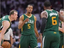  ?? Terrill, AP) (Photo by Mark J. ?? Utah Jazz guard Rodney Hood, center, celebrates with forward Joe Ingles, second from left, of Australia, and forward Joe Johnson, second from right, after scoring against the Los Angeles Clippers on Sunday.