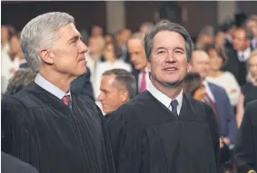  ?? Doug Mills, The New York Times, via The Associated Press ?? Supreme Court Associate Justices Neil Gorsuch, left, and Brett Kavanaugh watch as President Donald Trump arrives to give his State of the Union address to a joint session of Congress in February.