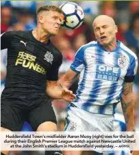  ??  ?? Huddersfie­ld Town’s midfielder Aaron Mooy (right) vies for the ball during their English Premier League match against Newcastle United at the John Smith’s stadium in Huddersfie­ld yesterday. –