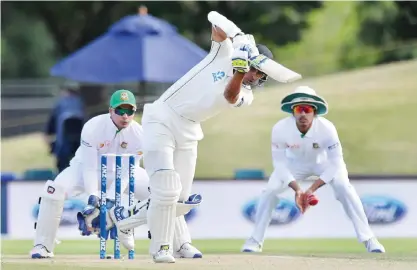  ??  ?? CHRISTCHUR­CH: New Zealand’s Jeet Raval (C) bats as Bangladesh wicketkeep­er Nurul Hasan (L) and Taijul Islam (R) looks on, during day four of the second internatio­nal Test cricket match between New Zealand and Bangladesh at Hagley Park Oval in...