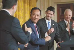  ?? GETTY IMAGES PHOTO ?? SHAKE ON IT: Foxconn CEO Terry Gou, second from left, is congratula­ted by Wisconsin Gov. Scott Walker, left, and House Speaker Paul Ryan after a deal was reach to build a $10 billion factory in Wisconsin.