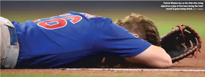  ?? GETTY IMAGES ?? Patrick Wisdom lies on the field after being injured on a play at first base during the Cubs’ recent 11-game losing streak.