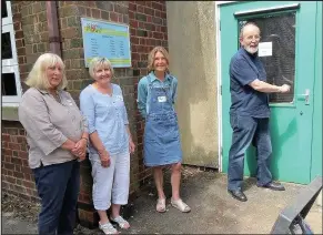  ??  ?? Former chairman Steve Kelly unlocks the doors at the library with Jenny Jennaway, Fiona Farquharso­n and Jean Darvill