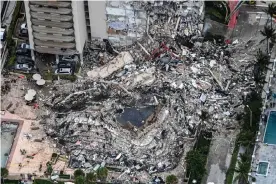  ?? AFP/Getty Images ?? Search and rescue personnel working on site after the partial collapse of the Champlain Towers South in Surfside, north of Miami Beach, on 13 July. Photograph: Chandan Khanna/