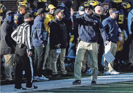  ?? JUNFU HAN/DETROIT FREE PRESS ?? Michigan coach Jim Harbaugh argues a call during a loss to Penn State on Nov. 28. Harbaugh has shown he will take a more active role in the team coming off a tumultuous 2-4 season.