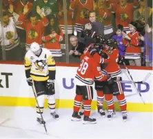  ?? Charles Rex Arbogast / Associated Press ?? Chicago’s Patrick Kane (88) celebrates No. 2 of three goals on the night with teammates Artemi Panarin and Nick Schmaltz.