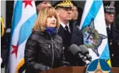  ?? ASHLEE REZIN GARCIA/SUN-TIMES ?? Erin Bauer, wife of slain CPD Cmdr. Paul Bauer, speaks at a memorial ceremony for her husband at the 18th Dist. police station on Thursday.