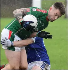  ??  ?? Andrew Mooney of Glen Emmets is challenged by Meath Hill’s James Mooney.