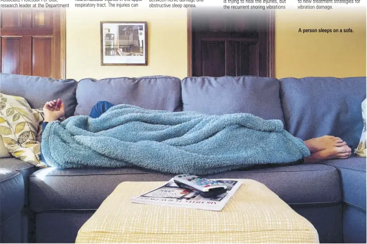  ??  ?? A person sleeps on a sofa.