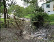  ??  ?? Wood Creek floodwater­s caused extensive damage in the Hall Street neighborho­od and displaced several families from their homes.