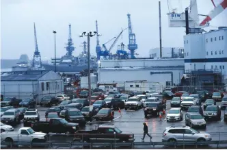  ?? — AP ?? In this Jan 3, 2017 photo, a shipyard worker walks to his car at the end of the workday at Bath Iron Works in Bath, Maine.