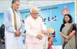  ?? HT PHOTO ?? ■ Haryana chief minister Manohar Lal Khattar lighting a lamp to inaugurate ITECH (Industry and Technical Excellence Changing Haryana) at Manesar in Gurugram on Wednesday. State technical education minister Ram Bilas Sharma is also seen in the picture.