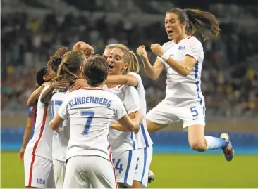  ?? EUGENIO SAVIO/ASSOCIATED PRESS ?? U.S. women's team members celebrate Carli Lloyd’s goal Saturday, and the Americans hung on for a 1-0 win over France.