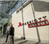  ?? THE ASSOCIATED PRESS ?? Two men stand outside the newly built Marriott Marquis hotel in Washington in 2015. Marriott Internatio­nal closed early Friday on its acquisitio­n of Starwood Hotels &amp; Resorts Worldwide.