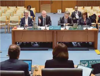  ?? BLOOMBERG PIC ?? Reserve Bank of Australia governor Philip Lowe (second from left) at a hearing before the House of Representa­tives economics committee in Canberra yesterday.