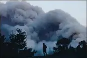  ?? NHAT V. MEYER — STAFF ARCHIVES ?? An onlooker watches as August CZU’s Lightning Complex fire burns near Pescadero in San Mateo County.