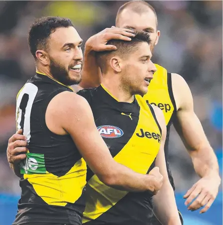  ?? Picture: AAP IMAGE ?? Tigers trio Shane Edwards, Dion Prestia and Kamdyn McIntosh embrace success during the AFL finals.