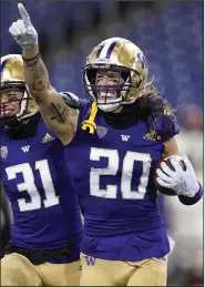  ?? (AP file photo) ?? Asa Turner’s Washington Huskies pulled out of the Pac-12 Championsh­ip Game on Monday due to covid-19 issues within the program. Washington Coach Jimmy Lake said the entire team is isolating as a precaution, and another round of testing for the entire team is scheduled for today.
