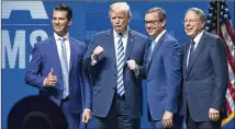  ?? SMILEY N. POOL / THE DALLAS MORNING NEWS ?? President Donald Trump stands with son Eric Trump (left), NRA-ILA Executive Director Chris Cox (second from right) and NRA Chief Executive Wayne LaPierre before addressing the NRA-ILA Leadership Forum on Friday in Dallas.