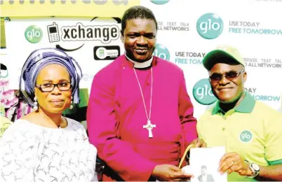  ??  ?? Executive Director, Legal Services, Globacom, Mrs Gladys Talabi (left) and Head, Mobile Money Financial Business, Globacom, Mr. Esaie Diei (right) presenting Mobile Money packs to Bishop of Lagos West Diocese, Anglican Communion, Rt. Reverend Dr. James...