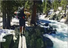  ?? AP PHOTO ?? In this June 16 photo, Jake Gustafson crosses Bear Creek along the Pacific Crest Trail near Kings Canyon National Park.